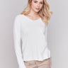 Ecru white V-neck sweater with long sleeves featuring side slits, made from plushy yarn by Charlie B.