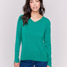 Forest green V-neck sweater with long sleeves featuring side slits, made from plushy yarn by Charlie B.