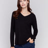 Black V-neck sweater with long sleeves featuring side slits, made from plushy yarn by Charlie B.