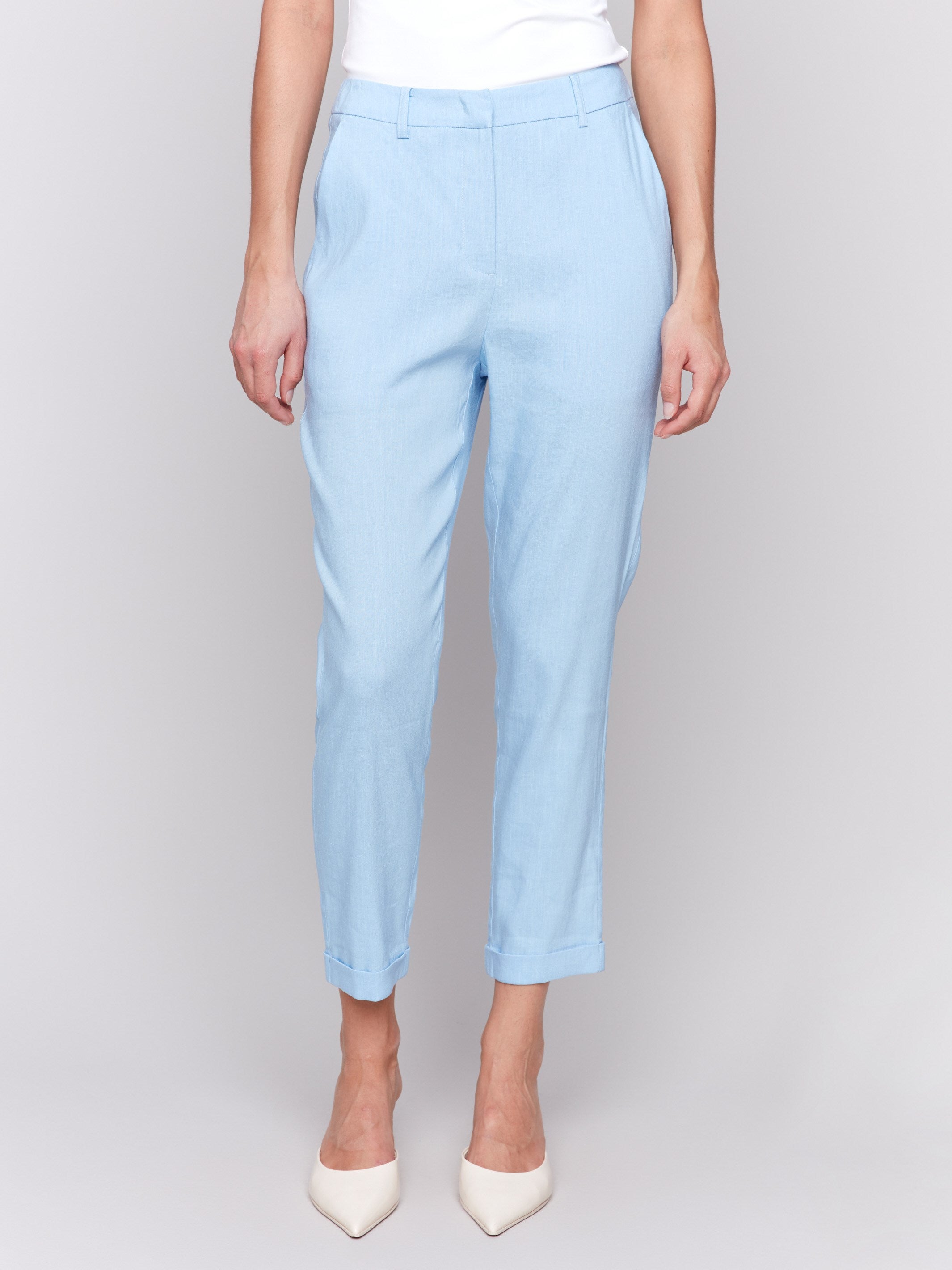 Light blue cropped pants with cuffed hem and slash pockets by Charlie B.