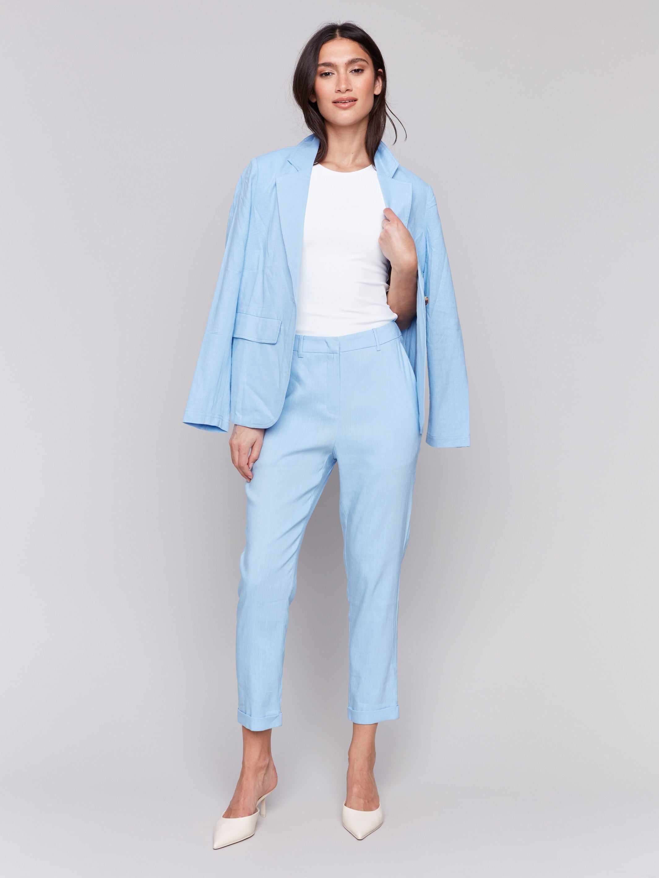 Light blue cropped pants with cuffed hem and slash pockets by Charlie B.