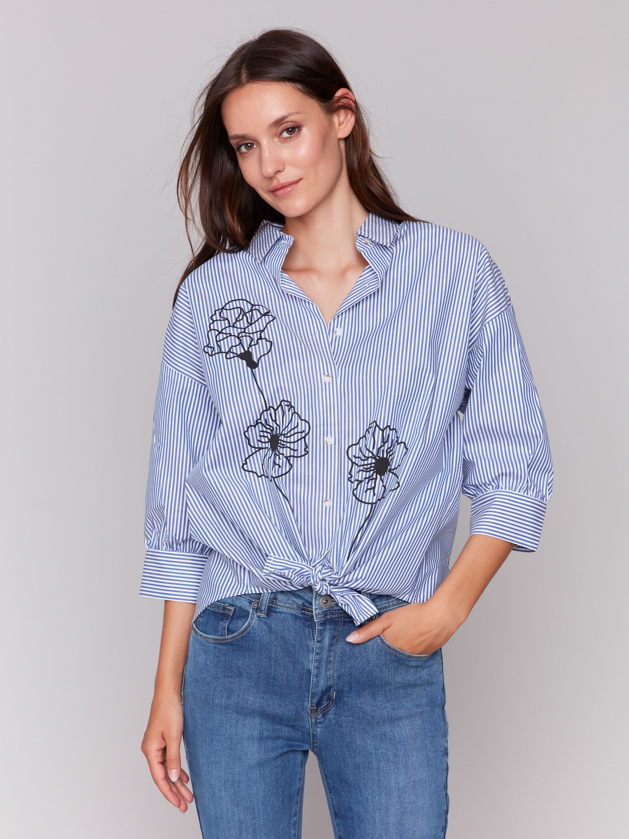 Blue striped blouse with a front tie and floral print overlay, featuring 3/4 sleeves by Charlie B.