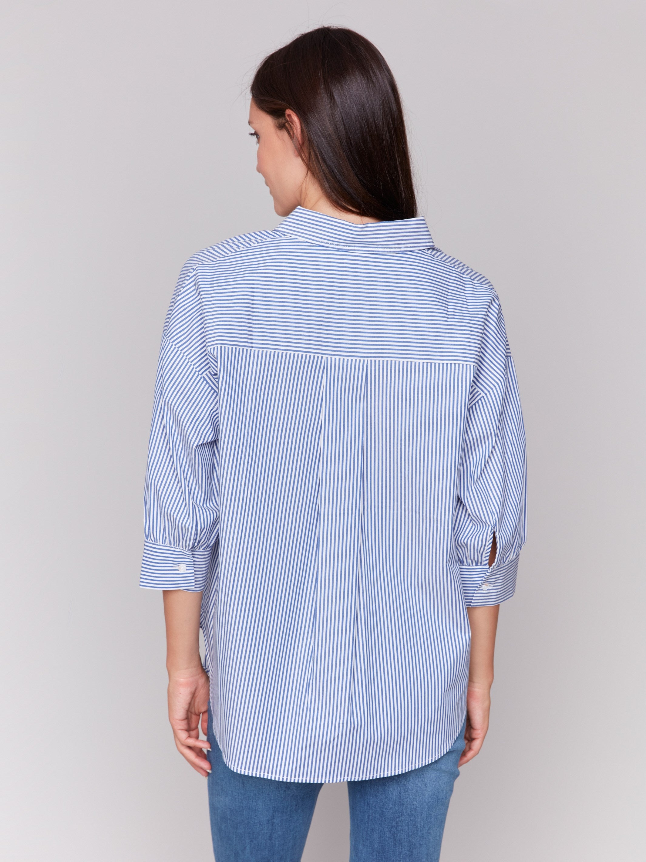 Blue striped blouse with a front tie and floral print overlay, featuring 3/4 sleeves by Charlie B.