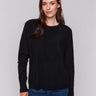 Black long-sleeve sweater with fringed embroidery, featuring a round neckline and ribbed cuffs by Charlie B.