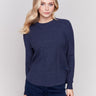 Denim blue sweater with long sleeves featuring side tab details and a round hem by Charlie B.