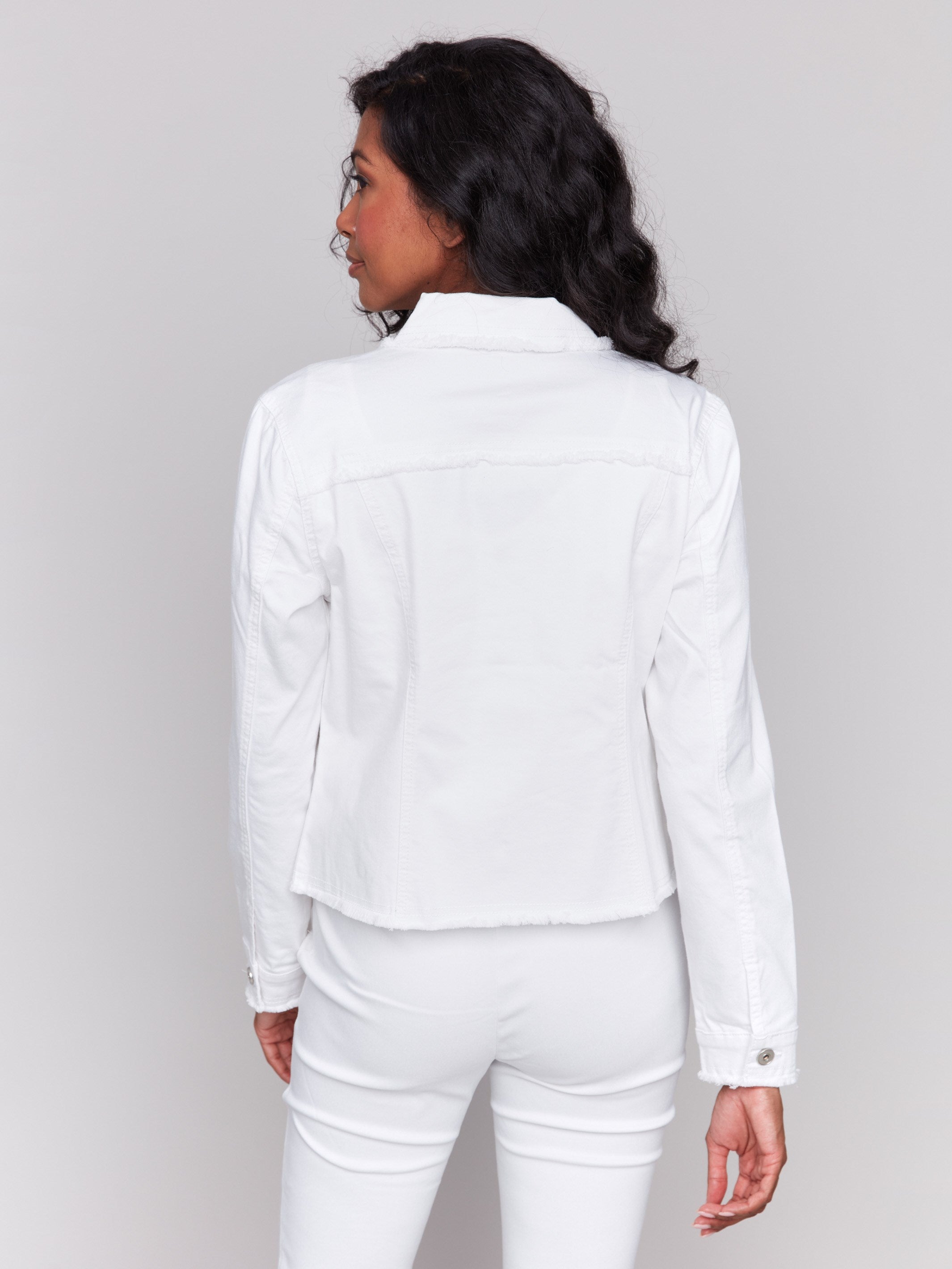 White twill jean jacket with frayed edges and front pockets by Charlie B.