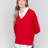 Cranberry V-neck fooler sweater with white shirt collar, featuring a shirttail hem and side slits by Charlie B.