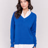 Sapphire V-neck fooler sweater with white shirt collar, featuring a shirttail hem and side slits by Charlie B.