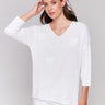 White V-neck knit top with heart appliqués, featuring drop shoulders, by Charlie B.