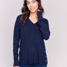 Navy-colored V-neck sweater with long sleeves featuring grommet details at the side placket by Charlie B.