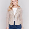 Beige faux leather jacket with rib knit sleeves, zipper details, and lapel collar by Charlie B.