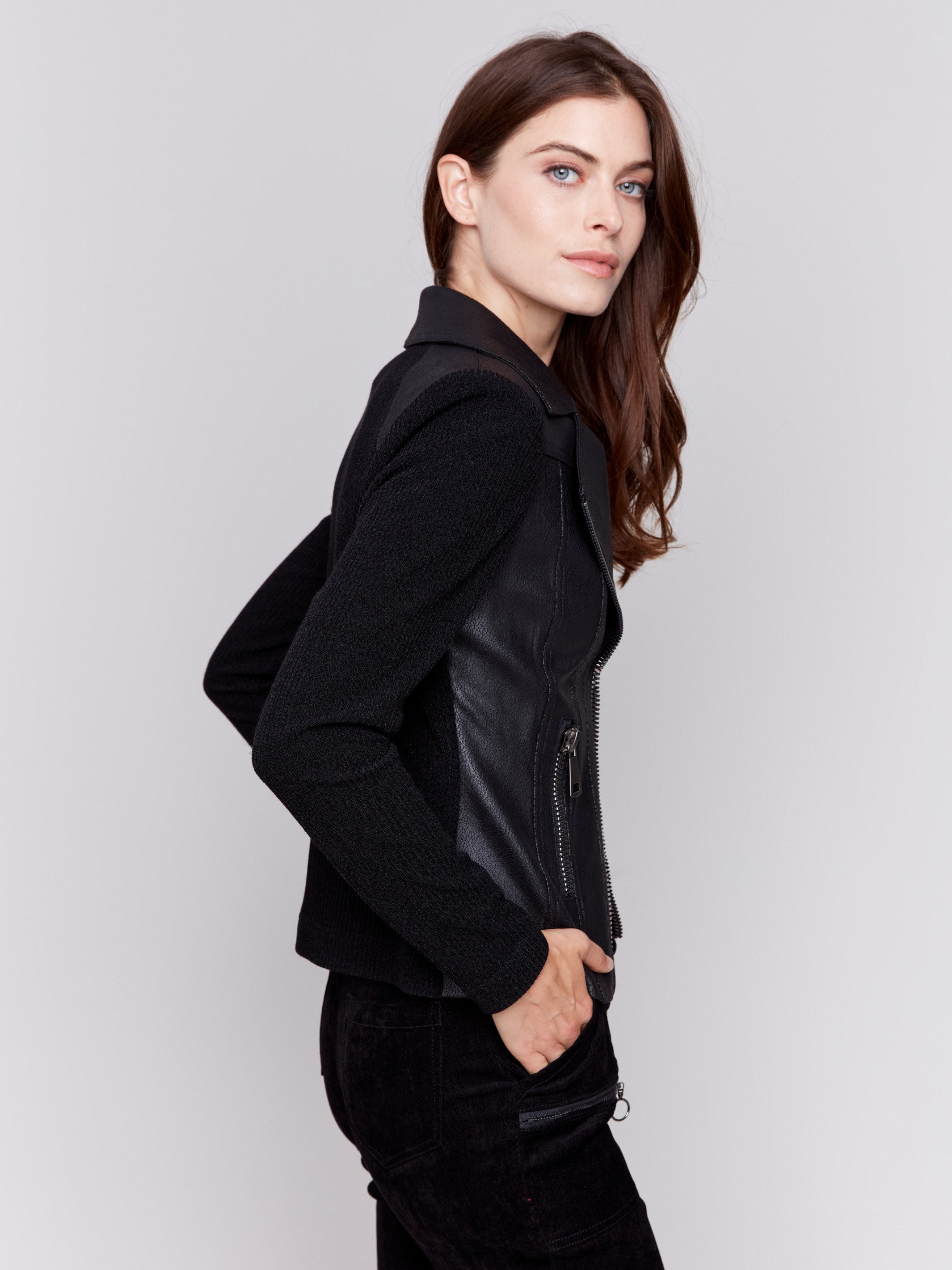 Black faux leather jacket with rib knit sleeves, zipper details, and lapel collar by Charlie B.