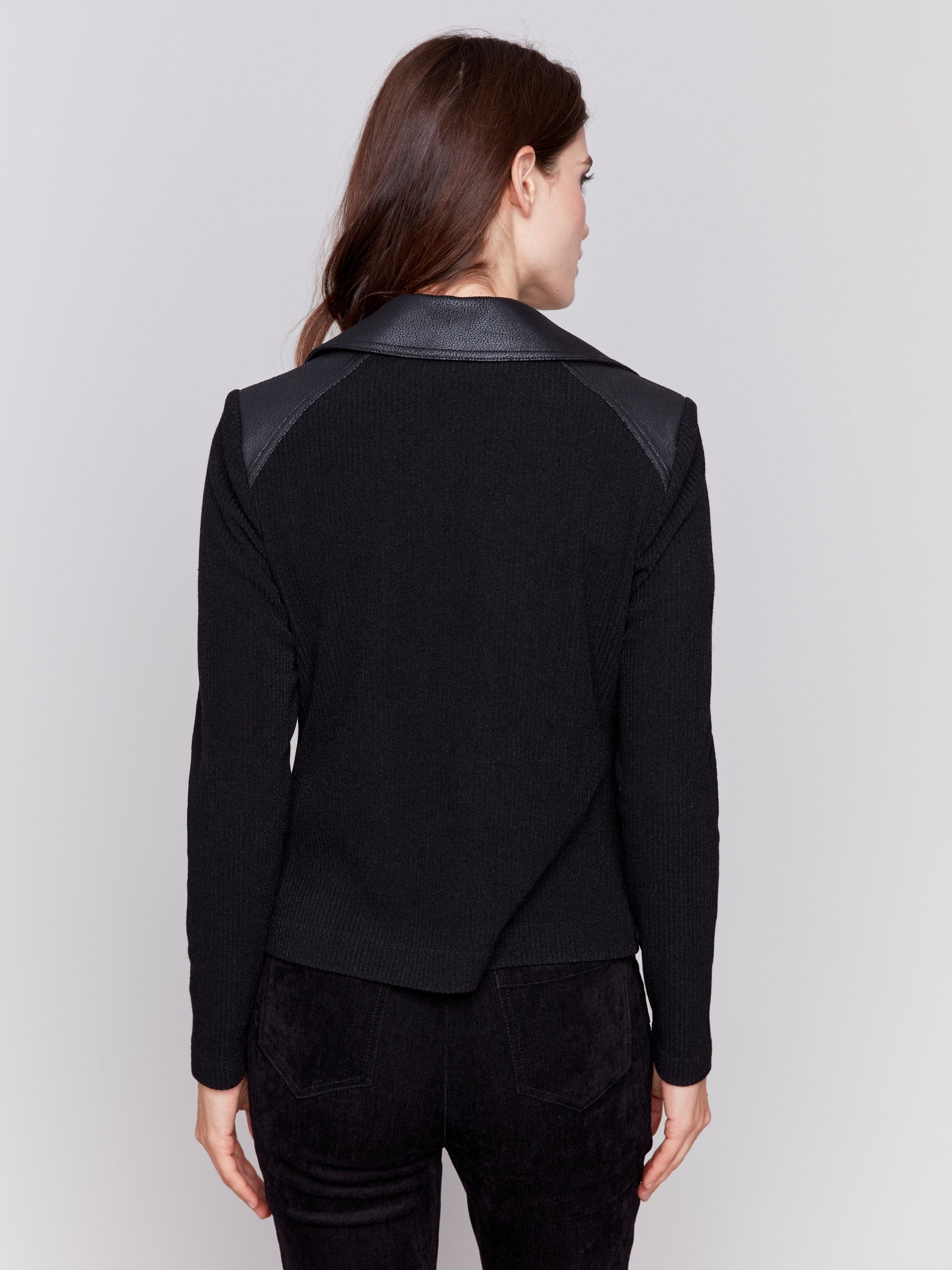 Black faux leather jacket with rib knit sleeves, zipper details, and lapel collar by Charlie B.