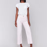 Light pink wide-leg twill pants with raw edge hem, five-pocket design, and regular rise by Charlie B.